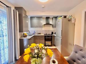 伯明翰Guest House Rooms Birmingham的厨房配有木桌和冰箱。