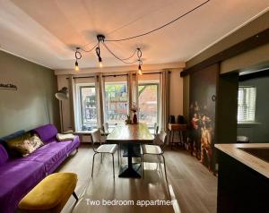 霍恩Appartementen in het centrum van Hoorn的客厅配有紫色沙发和桌子