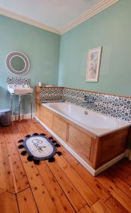 PrestonpansLuxury 5-bed Villa - Winfields House的铺有木地板的客房内设有一个大浴缸