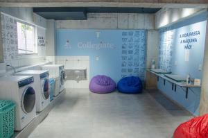圣若昂-德雷Studio 900m do centro, prédio com piscina, sauna, academia e lavanderia的浴室设有两台洗衣机和紫色豆袋