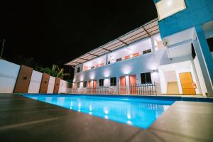 瓜埠The Concept Hotel Langkawi的夜间在房子前面的游泳池