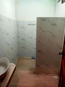 高龙撒冷岛甜蜜时光旅馆的一间带水槽的浴室和一扇带大理石墙壁的门