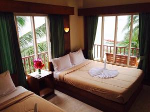 哈林海滩布莱克先生度假旅馆的酒店客房设有两张床和一个阳台。