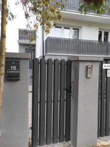 拉多姆Komfortowe przytulne nowoczesne mieszkanie Radom的房屋前的黑色围栏