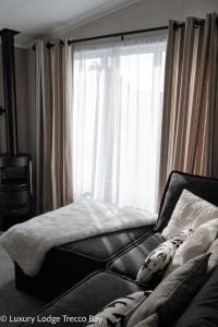 波斯考尔Holiday Lodge 6的一间卧室设有一张床和一个大窗户
