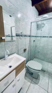 邦比尼亚斯Residencial Morro Macaco Apartamentos的一间带卫生间和玻璃淋浴间的浴室