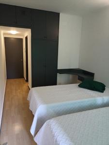 丰沙尔Alojamento Central - Funchal的一间卧室配有两张床和橱柜。
