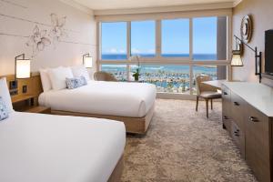 檀香山威基基普林斯酒店的酒店客房配有两张床和一张书桌
