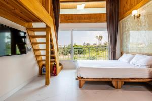 济州市Aewol Oceanstay的一间卧室设有一张床、楼梯和窗户