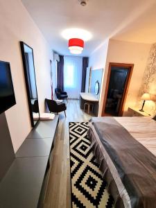 CristeştiMotel Via Targu Mures的一间卧室配有一张床、一台电视和一张书桌