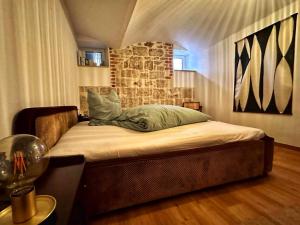 魏玛RÖSCH Apartment的石墙房间内的一张床位