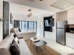 迪拜Luxury Modern Studio in JLT with Amazing View & Rooftop Pool - sleeps 3的带沙发的客厅和厨房