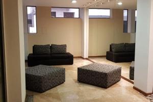 罗萨里奥Departamento luminoso amplio y silencioso.的带沙发和脚凳的客厅