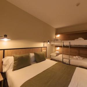 安道尔城梅非尼酒店的一间卧室配有两张床和两张双层床。