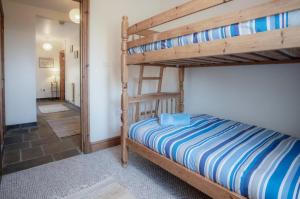 罗西里Fferm-Llong Cottage Ship Farm - 2 Bedroom -Rhossili的一间带两张双层床的卧室和走廊