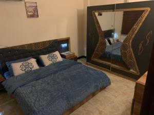 巴格达Dreams Apartments شقق الاحلام的一间卧室配有一张床和一面大镜子