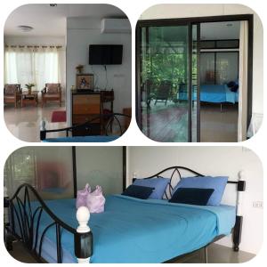 Ban Huai PhaiThe Ozone station的一间带蓝色床的卧室和一间客厅