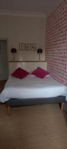 米尔芒德米曼德酒店的一间卧室配有一张带红色枕头的大床