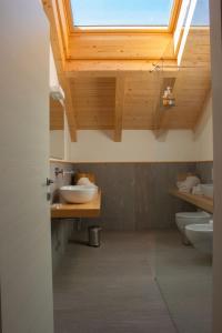 巴尔齐奥B&B Villa Cavallier的一间带两个水槽和天窗的浴室