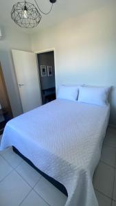 桑托斯Apartamento Frente ao Mar Santos II的卧室配有白色床单和白色大床