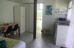 阿鲁坦加蓝姬尼斯度假酒店的客房设有厨房和带桌子的房间