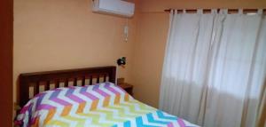 费德拉西翁Pucará的一间卧室配有床和带窗帘的窗户
