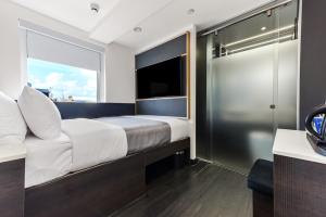 伦敦The Z Hotel Strand的一间卧室设有一张大床和一个大窗户