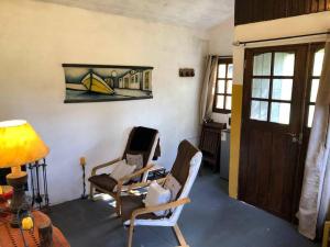 库奇拉阿尔塔La Cabaña Celeste的客厅配有两把椅子和一扇门