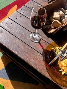 库奇拉阿尔塔La Cabaña Celeste的一杯葡萄酒坐在一盘食物旁边