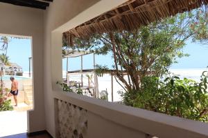 江比阿Red Monkey Beach Lodge的一间客房,从阳台上可欣赏到海滩景色