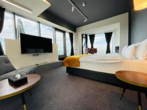 胡内多阿拉WERK Hotel & SPA的一间酒店客房,配有一张大床和一台平面电视