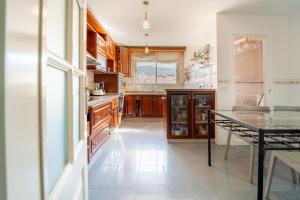 哈恩Duplex Luz的厨房配有木制橱柜和玻璃桌