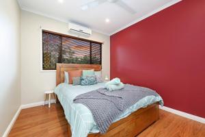 NightcliffA Tropical Pool Paradise in Rapid Creek的一间卧室设有一张床和红色的墙壁