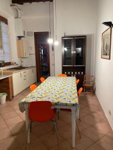 比萨Artemisia的厨房里配有带橙色椅子的餐桌