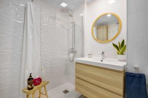 马拉加MÁlaga Playa的浴室配有盥洗盆和带镜子的淋浴