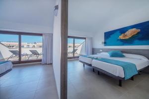 休达德亚Aparthotel Ferrer Skyline的一间带两张床的卧室,享有海景