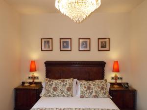 Ventosa拉斯哥达斯乡村旅馆的一间卧室配有一张带两盏灯和吊灯的床。
