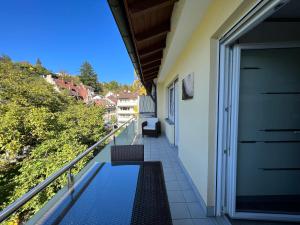 巴登-巴登Deluxe Apartment Baden-Baden的房屋的阳台,上面有长凳