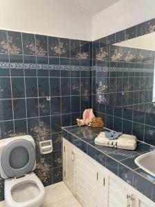 拉巴斯Apartamento de lujo con jardines paisajísticos的蓝色瓷砖浴室设有卫生间和水槽
