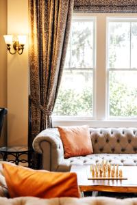 阿什维尔Princess Anne Boutique Hotel & Breakfast的带沙发和窗户的客厅