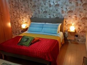 巴列塔Casa-B&B Bouganville Attico 85 mq的一间卧室配有一张带红毯的床和两盏灯。