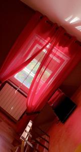 Damparis德拉伯德多迈恩酒店的红色的天篷,窗户在房间内