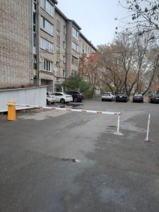 彼得罗巴甫洛夫斯克Дизайнерская квартира в ста метрах от городского парка的停车场内一个带障碍物的停车场