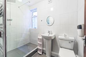 伦敦Stunning, large 1 bed riverside flat的白色的浴室设有卫生间和水槽。