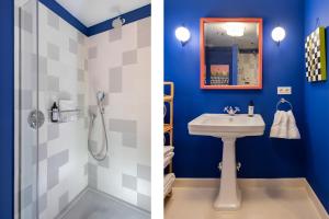 塞维利亚CSE San Bernardo的浴室设有蓝色的墙壁、水槽和淋浴。