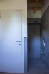 巴尔齐奥B&B Villa Cavallier的浴室设有白色门,配有淋浴
