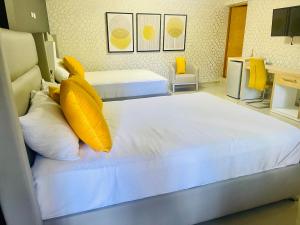 El Paso Hotel的两张带黄色枕头的床