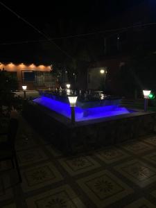 Dawmat al Jandalفندق ادوماتو ADOMATo HOTEl的夜间拥有蓝色灯光的游泳池
