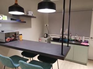 福隆港80 Colonie Fraser's Hill的厨房配有桌子和2把蓝色椅子