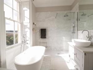 德斯利Rockstowes House的白色的浴室设有2个盥洗盆和淋浴。